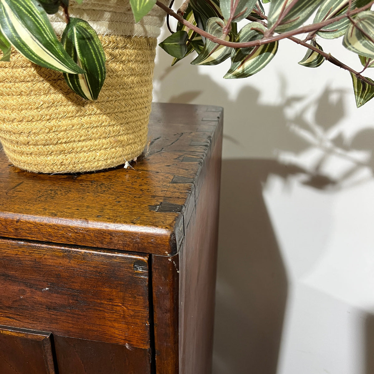A charming antique mahogany cupboard featuring a beautifully figured flame mahogany panelled door with its original brass escutcheon and rich aged patina.