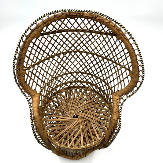 This is a vintage wicker rattan Miniture Peacock Chair with a bohemian pattern. A fun decorative item that can be used to display a plant, teddy or doll.