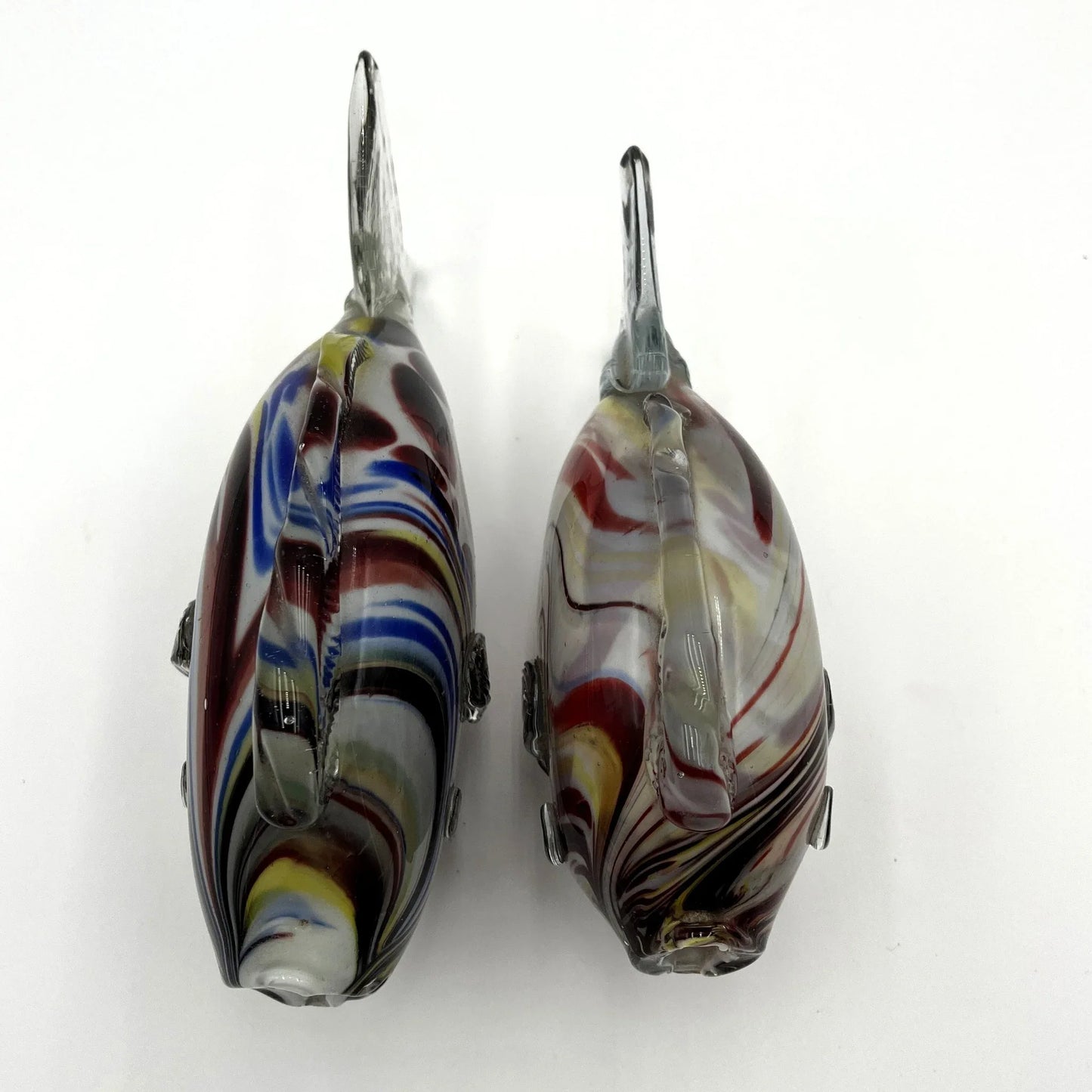 This is a pair of mid-century Spatter, End of Day, or marbled fish. They feature a colourful marbled design with clear glass fins.