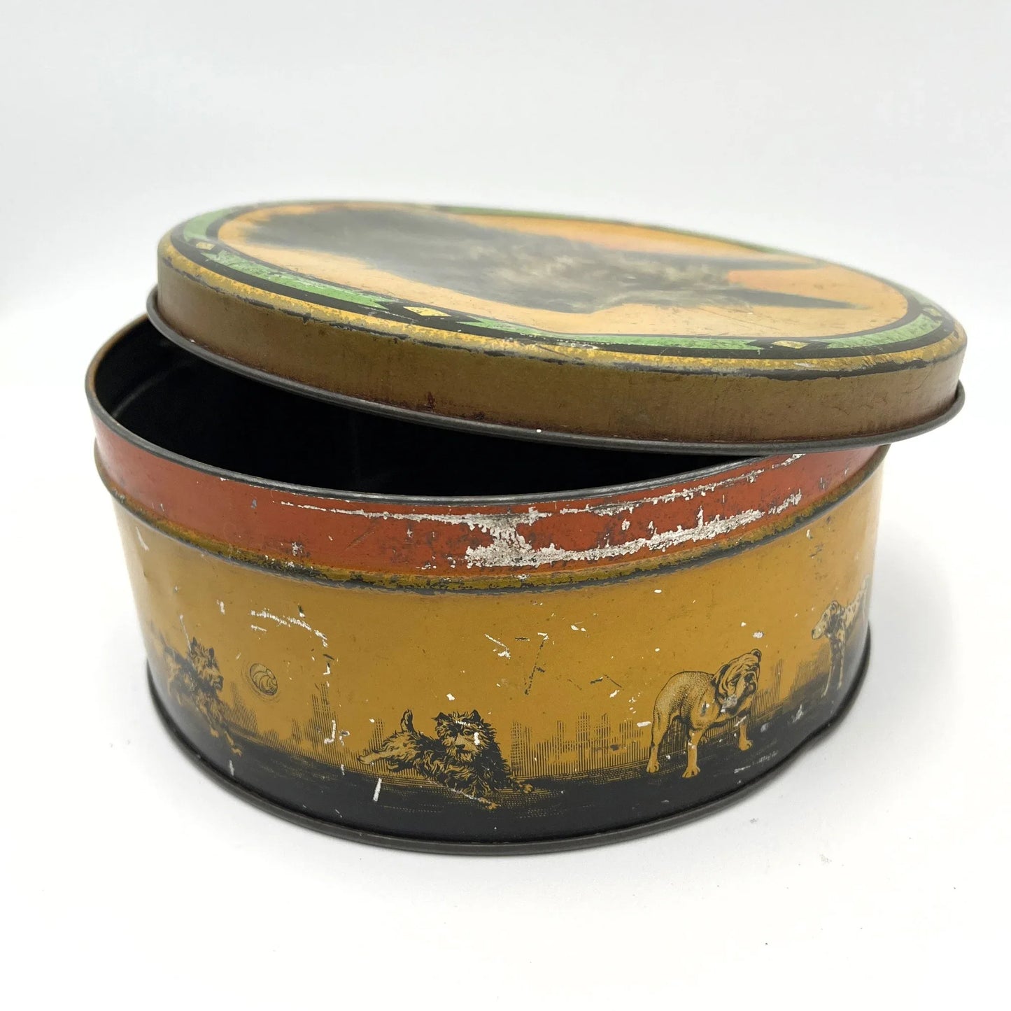 This is a smaller Pictorial Dog Mackintosh's Keillers Vintage Advertising toffee tin. It has a lovely picture of a Terrier on the lid and an assortment of dog breeds depicted around the sides of the tin.