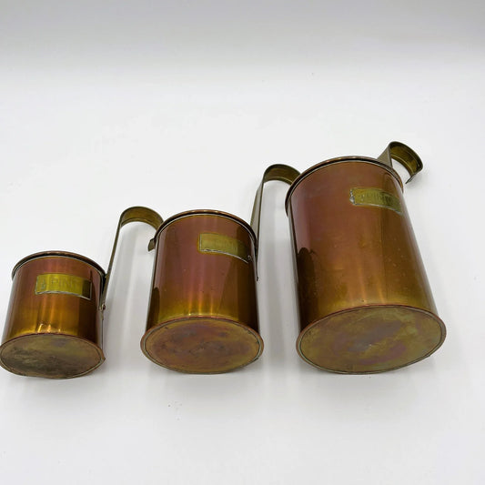 This is a set of Vintage Copper and brass Measuring Cup Ladles. A Set of comprising of 2 Pint 1 Pint 1/2 Pint. Originally used by a pub to measure ale or cider. They are made of copper with brass capacity labels and hooked handles for hanging