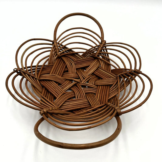 This is a vintage bread or fruit basket with a Celtic knot weave pattern.
It is a decorative wicker or willow basket often used for serving bread or fruit.