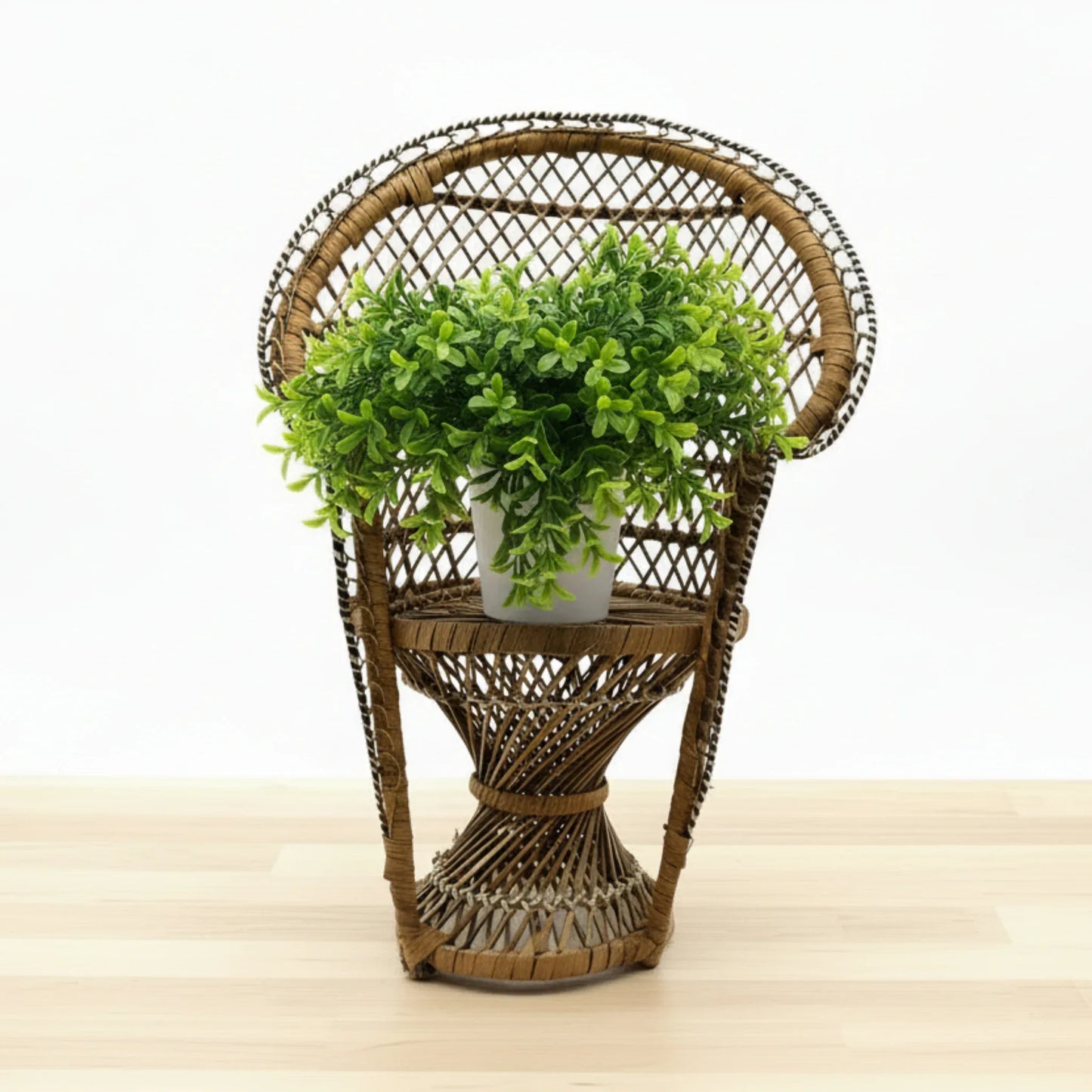 This is a vintage wicker rattan Miniture Peacock Chair with a bohemian pattern. A fun decorative item that can be used to display a plant, teddy or doll.