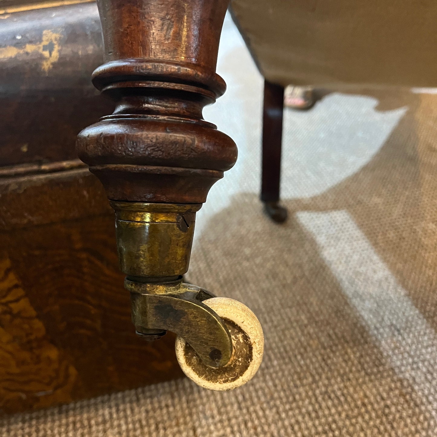 A handsome late Victorian mahogany open armchair, dating from the late 19th century, featuring beautifully carved scroll arms, turned front legs and original brass and ceramic castors.