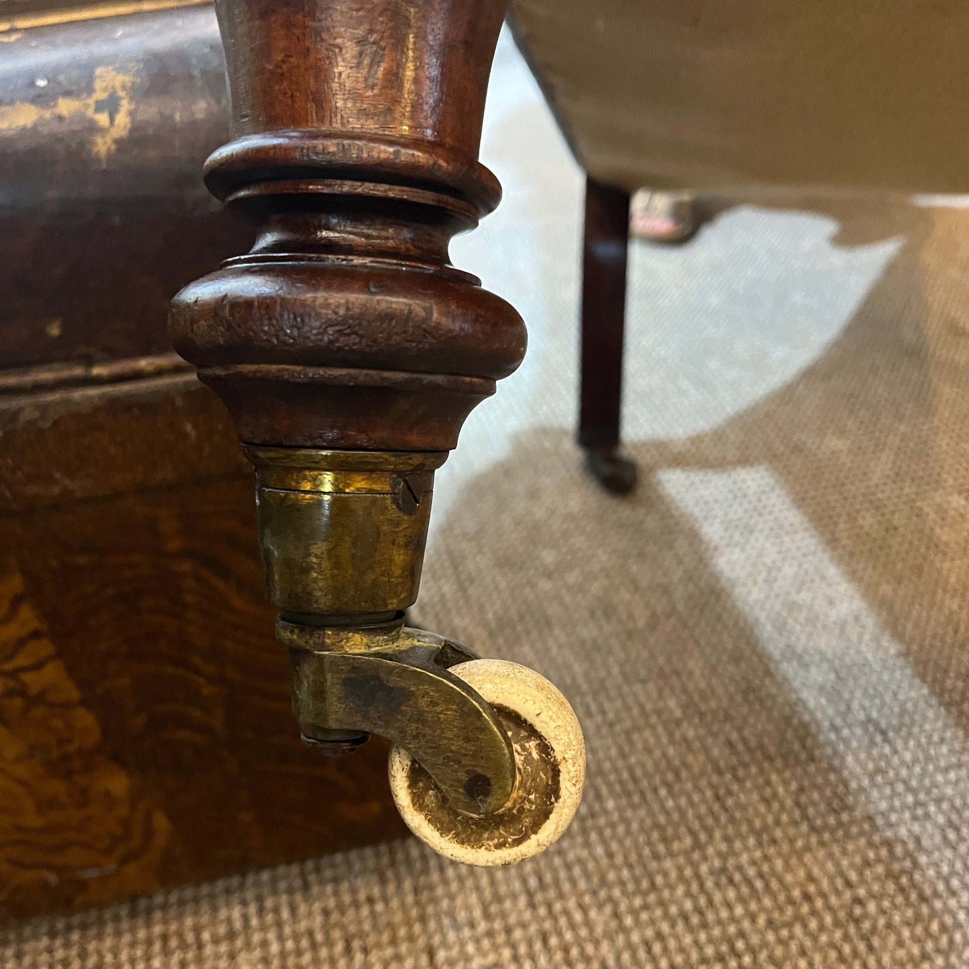 A handsome late Victorian mahogany open armchair, dating from the late 19th century, featuring beautifully carved scroll arms, turned front legs and original brass and ceramic castors.