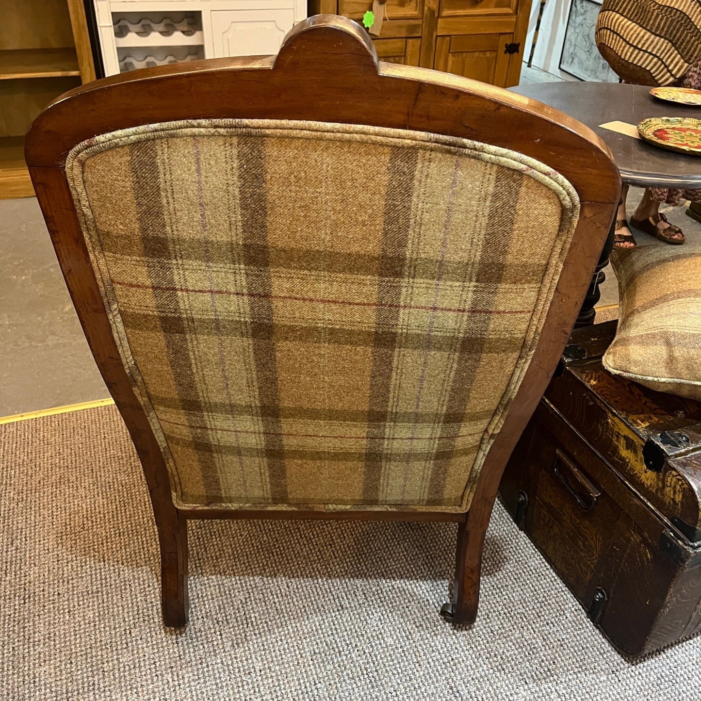A handsome late Victorian mahogany open armchair, dating from the late 19th century, featuring beautifully carved scroll arms, turned front legs and original brass and ceramic castors.
