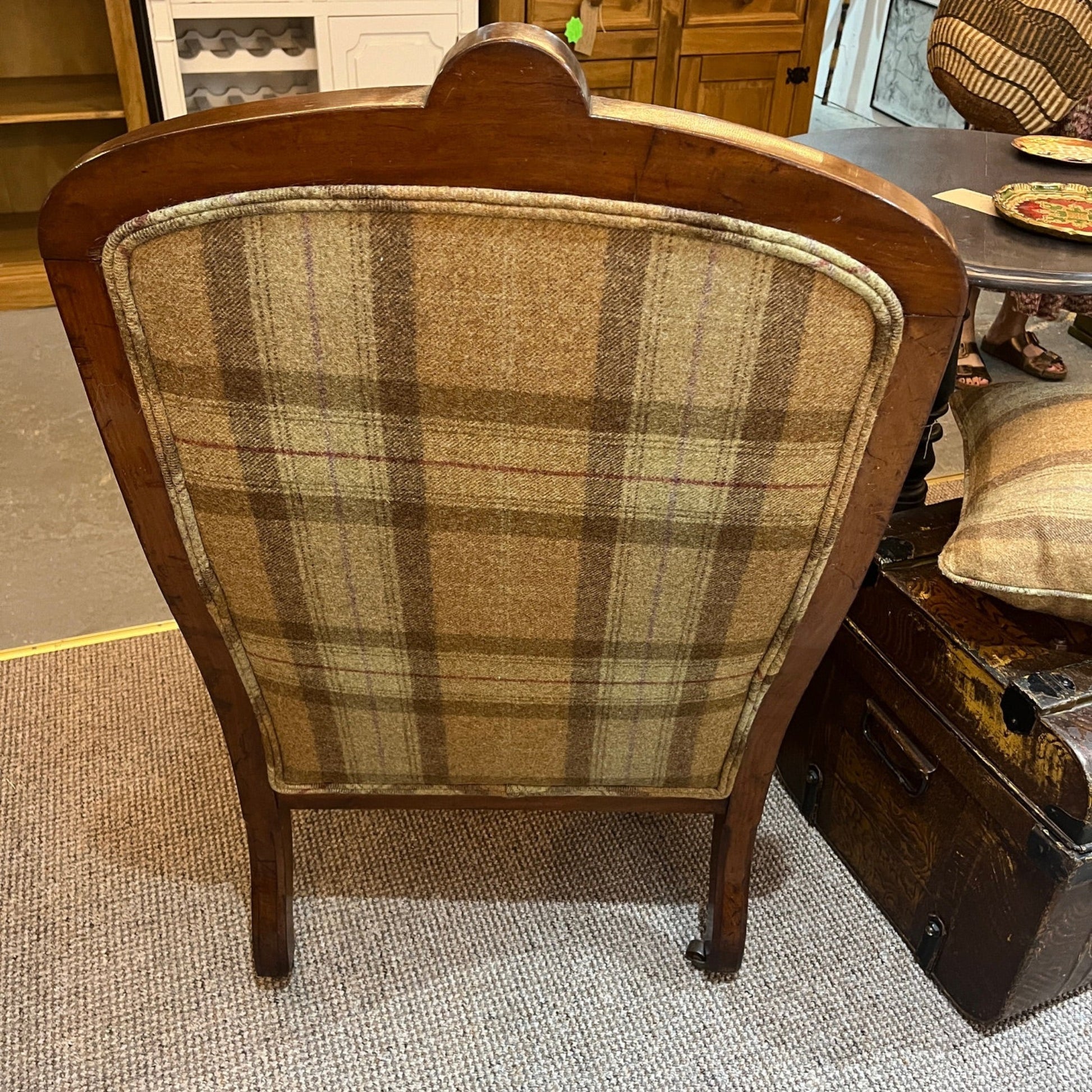 A handsome late Victorian mahogany open armchair, dating from the late 19th century, featuring beautifully carved scroll arms, turned front legs and original brass and ceramic castors.