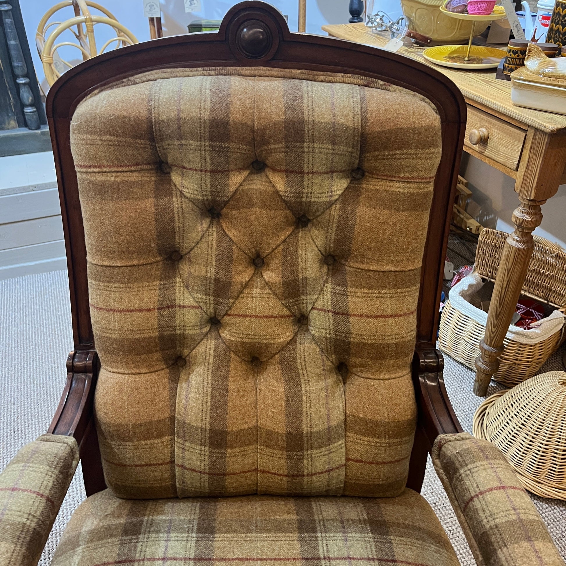 A handsome late Victorian mahogany open armchair, dating from the late 19th century, featuring beautifully carved scroll arms, turned front legs and original brass and ceramic castors.