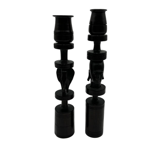 Pair of African black ebony candle holders with decorative carved elephant and face.