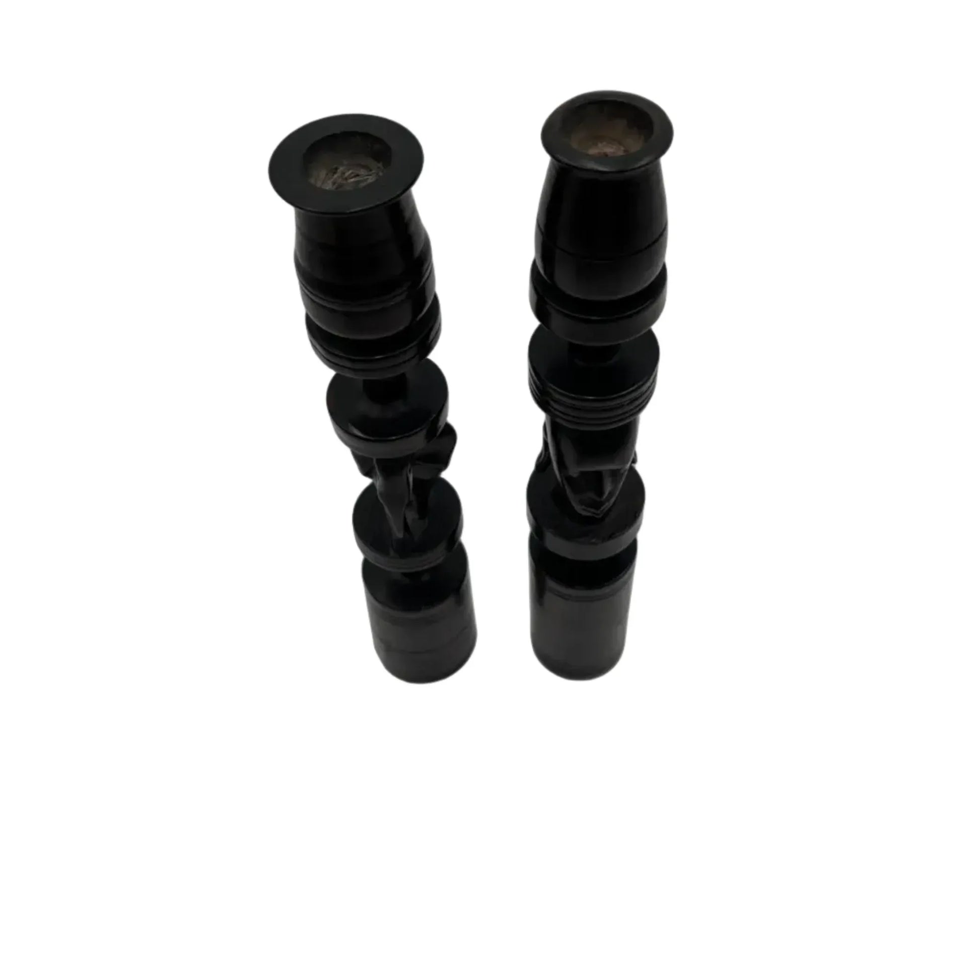 Pair of African black ebony candle holders with decorative carved elephant and face.