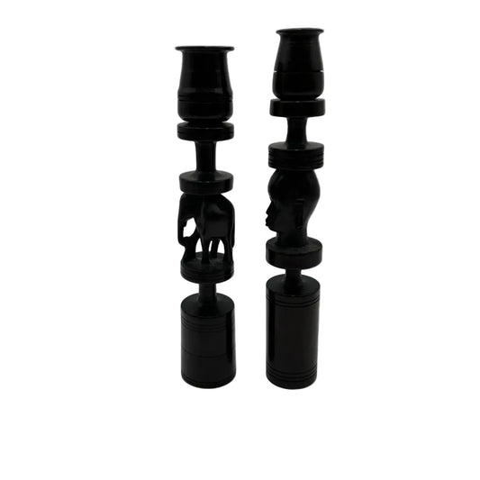 Pair of African black ebony candle holders with decorative carved elephant and face.