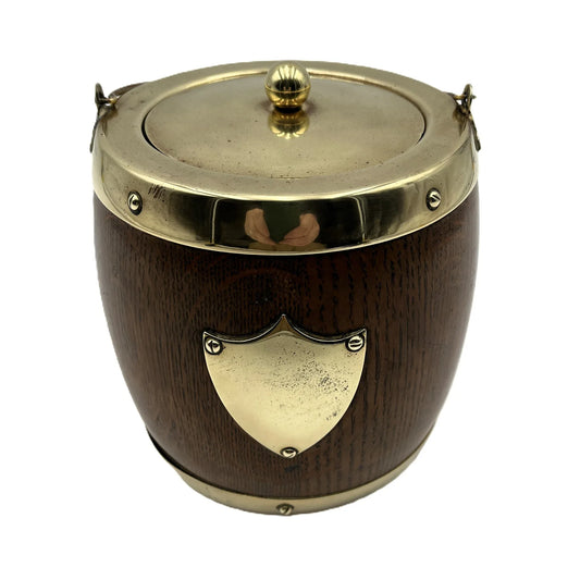 This is an Antique English Oak Biscuit Barrel, Tobacco Jar, or Ice Bucket with a porcelain liner, 