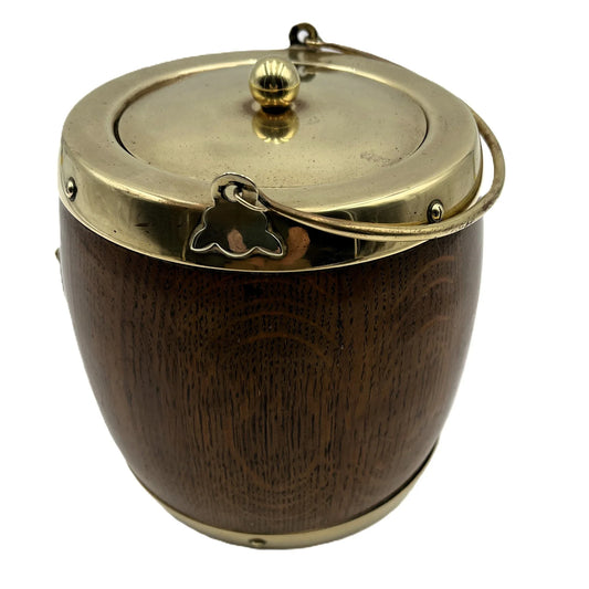 This is an Antique English Oak Biscuit Barrel, Tobacco Jar, or Ice Bucket with a porcelain liner, 
