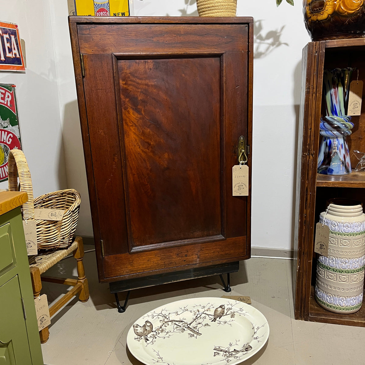 A charming antique mahogany cupboard featuring a beautifully figured flame mahogany panelled door with its original brass escutcheon and rich aged patina.