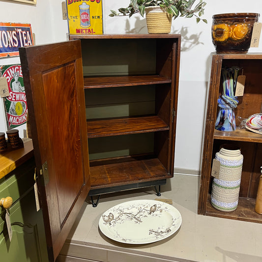 A charming antique mahogany cupboard featuring a beautifully figured flame mahogany panelled door with its original brass escutcheon and rich aged patina.