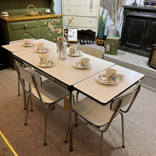 This is a 1950s or 60s Tavos Formica Kitchen Table and chairs. Formica table top, chair seats and backrests supported by very clean chrome metal work.
