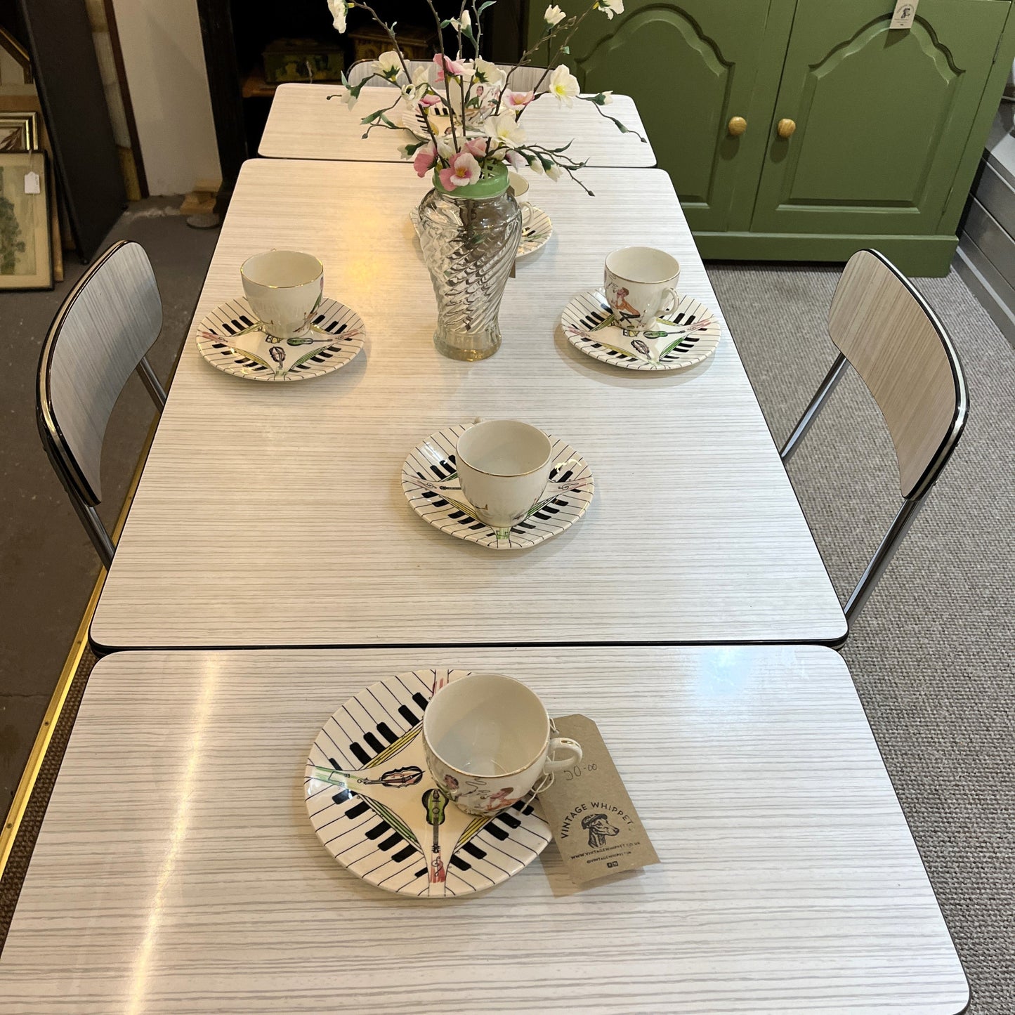 This is a 1950s or 60s Tavos Formica Kitchen Table and chairs. Formica table top, chair seats and backrests supported by very clean chrome metal work.