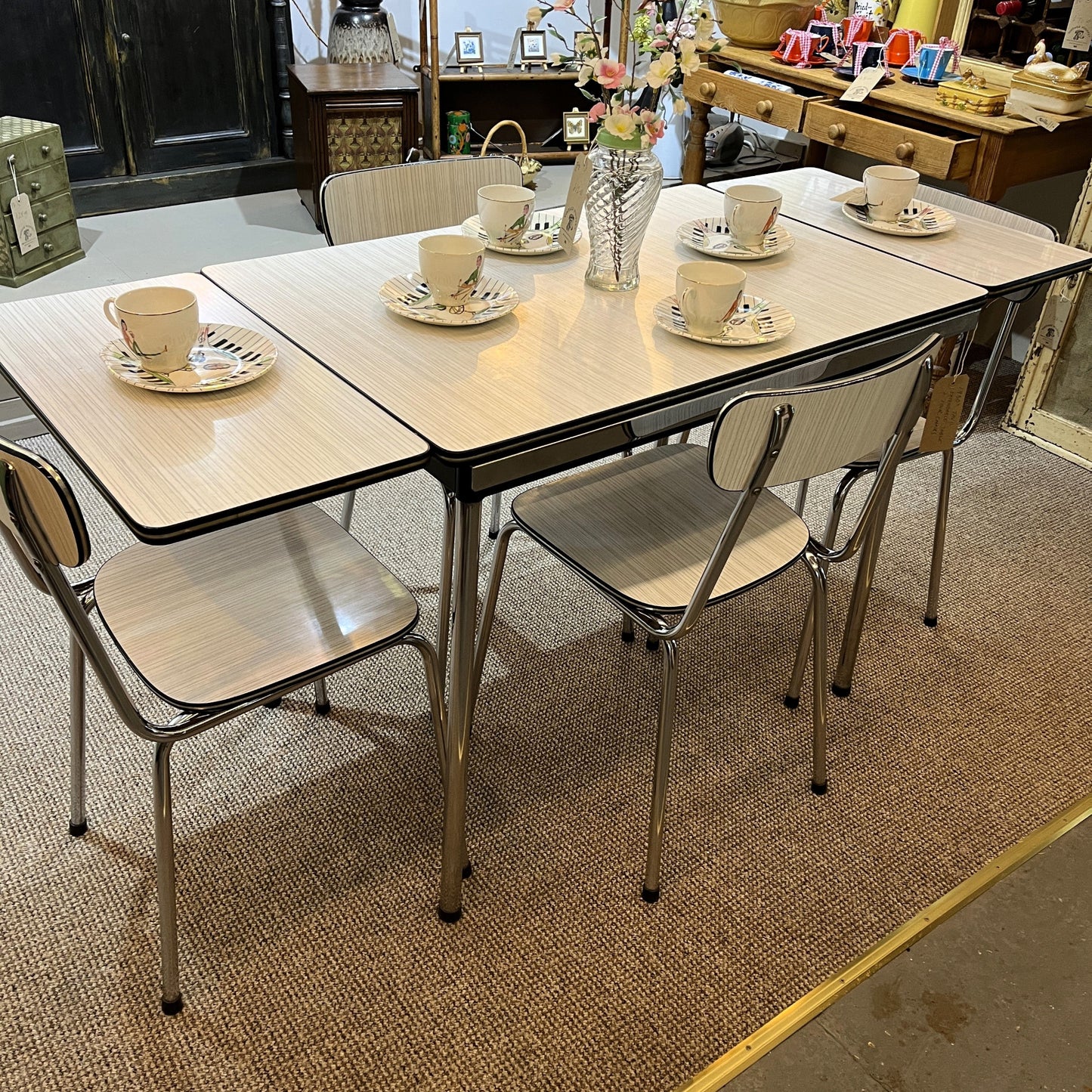 This is a 1950s or 60s Tavos Formica Kitchen Table and chairs. Formica table top, chair seats and backrests supported by very clean chrome metal work.