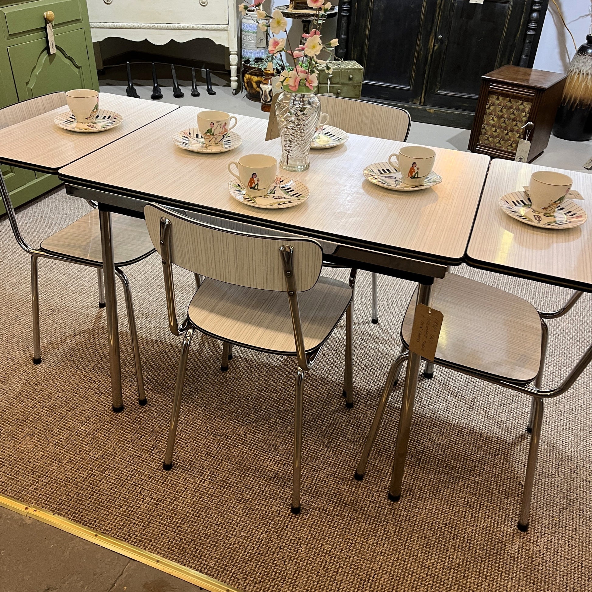 This is a 1950s or 60s Tavos Formica Kitchen Table and chairs. Formica table top, chair seats and backrests supported by very clean chrome metal work.