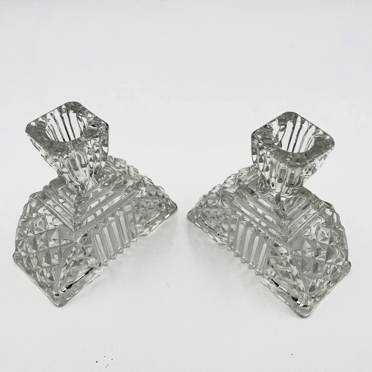 This is a Pair of Walther and Sohne 1930s-1940s Vintage Pressed Glass Candlesticks. 