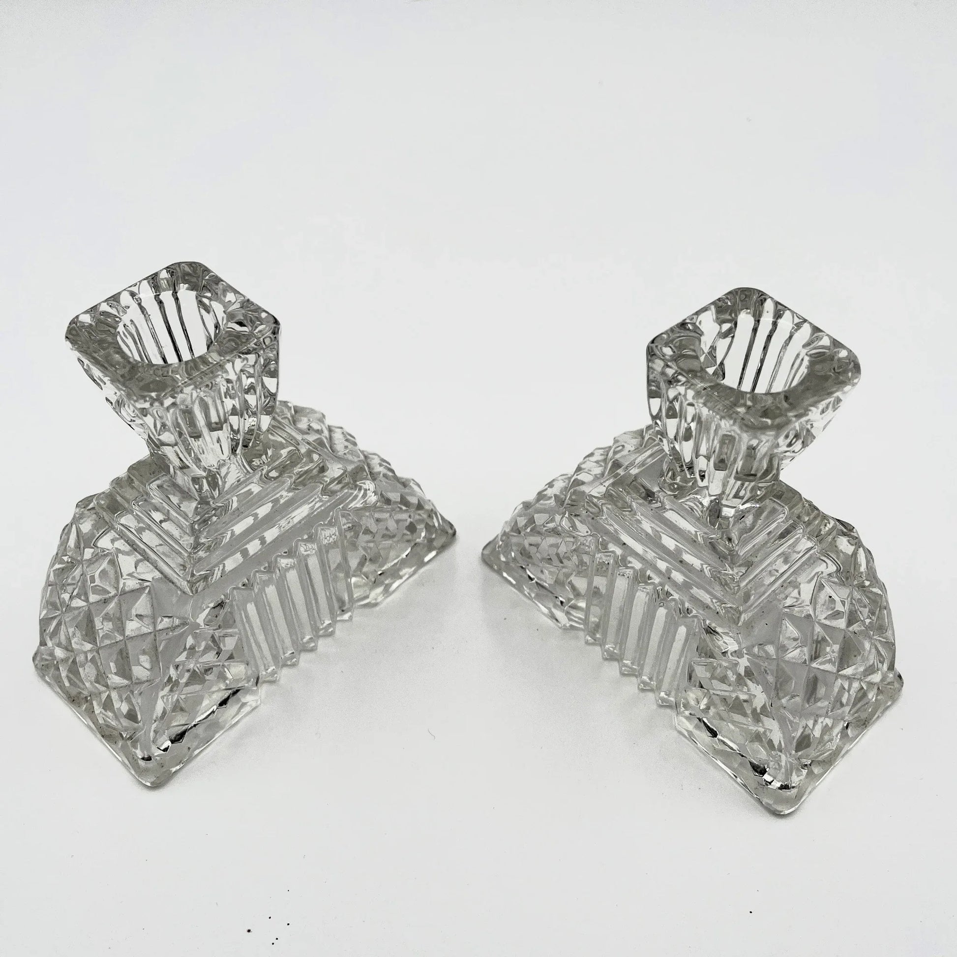 This is a Pair of Walther and Sohne 1930s-1940s Vintage Pressed Glass Candlesticks. 