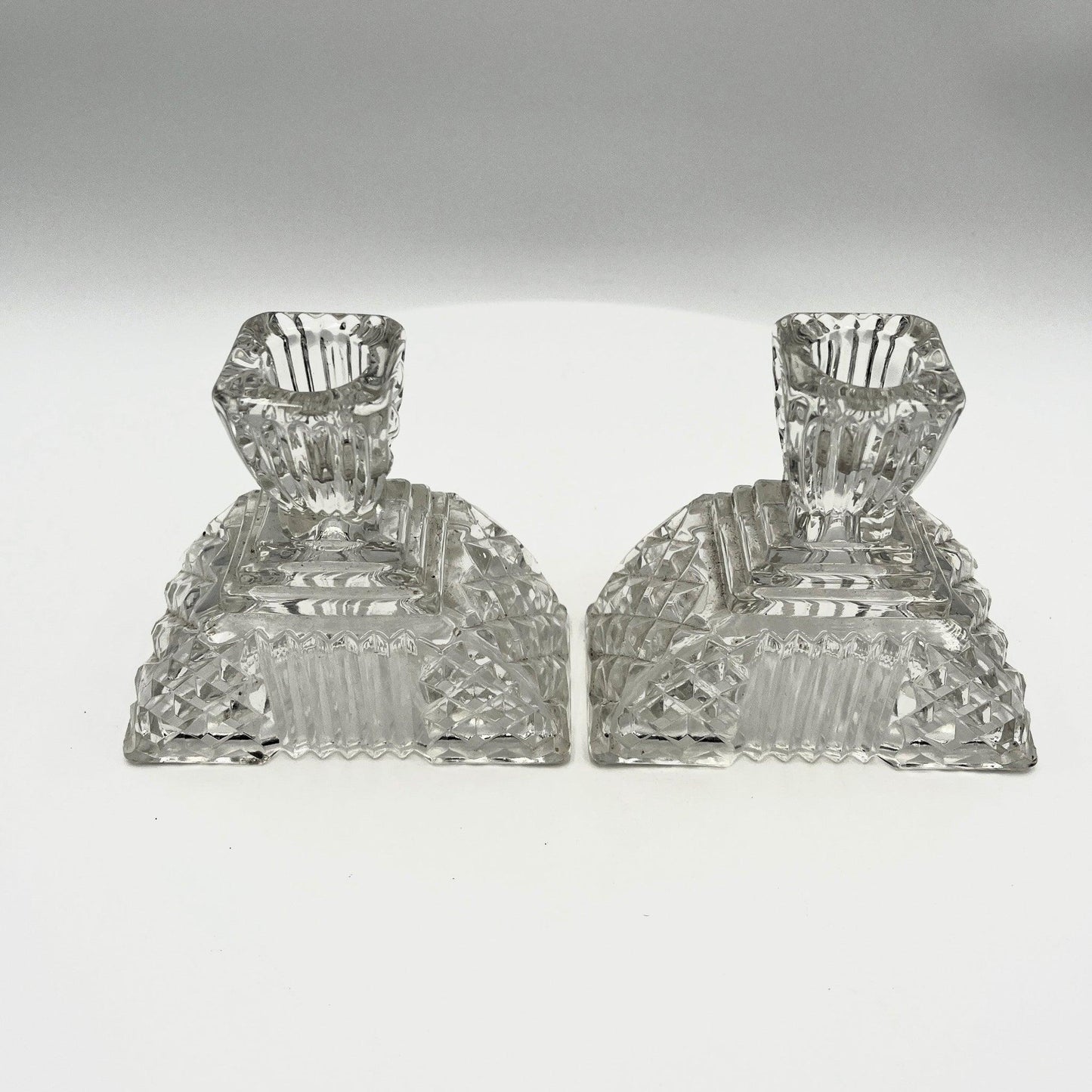 This is a Pair of Walther and Sohne 1930s-1940s Vintage Pressed Glass Candlesticks. 