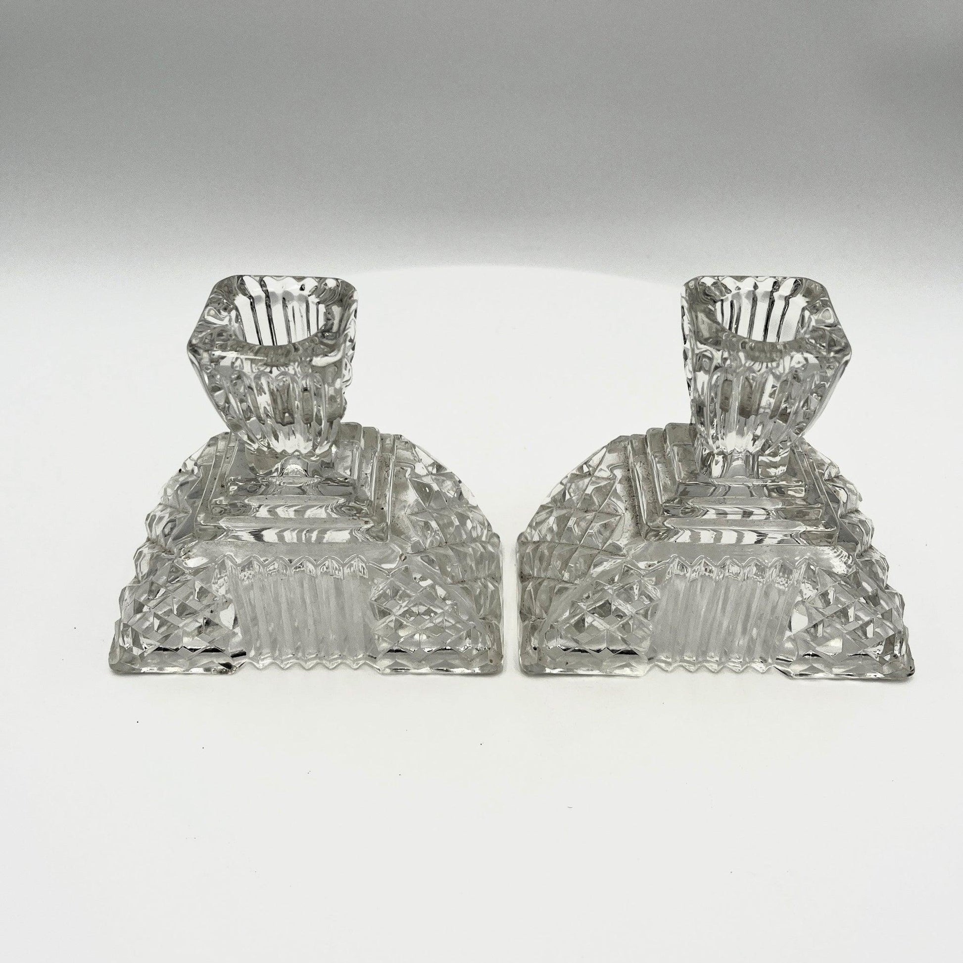 This is a Pair of Walther and Sohne 1930s-1940s Vintage Pressed Glass Candlesticks. 