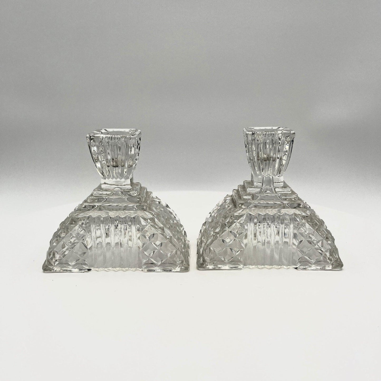 This is a Pair of Walther and Sohne 1930s-1940s Vintage Pressed Glass Candlesticks. 