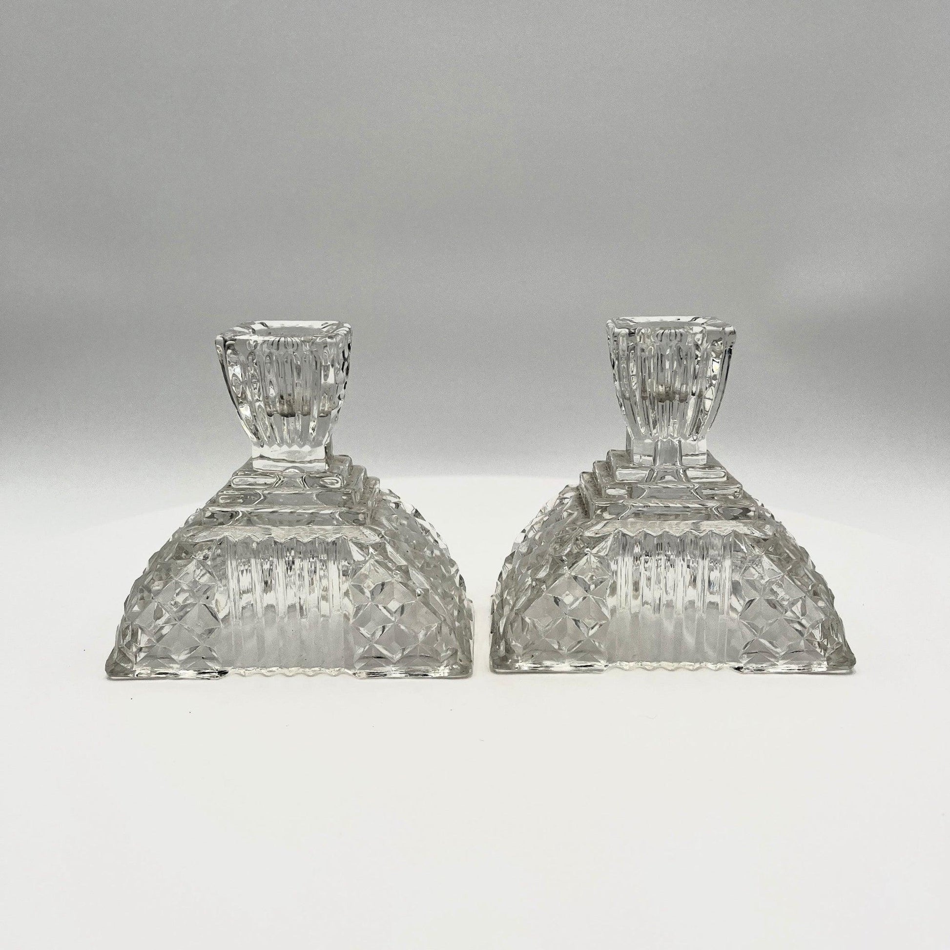 This is a Pair of Walther and Sohne 1930s-1940s Vintage Pressed Glass Candlesticks. 