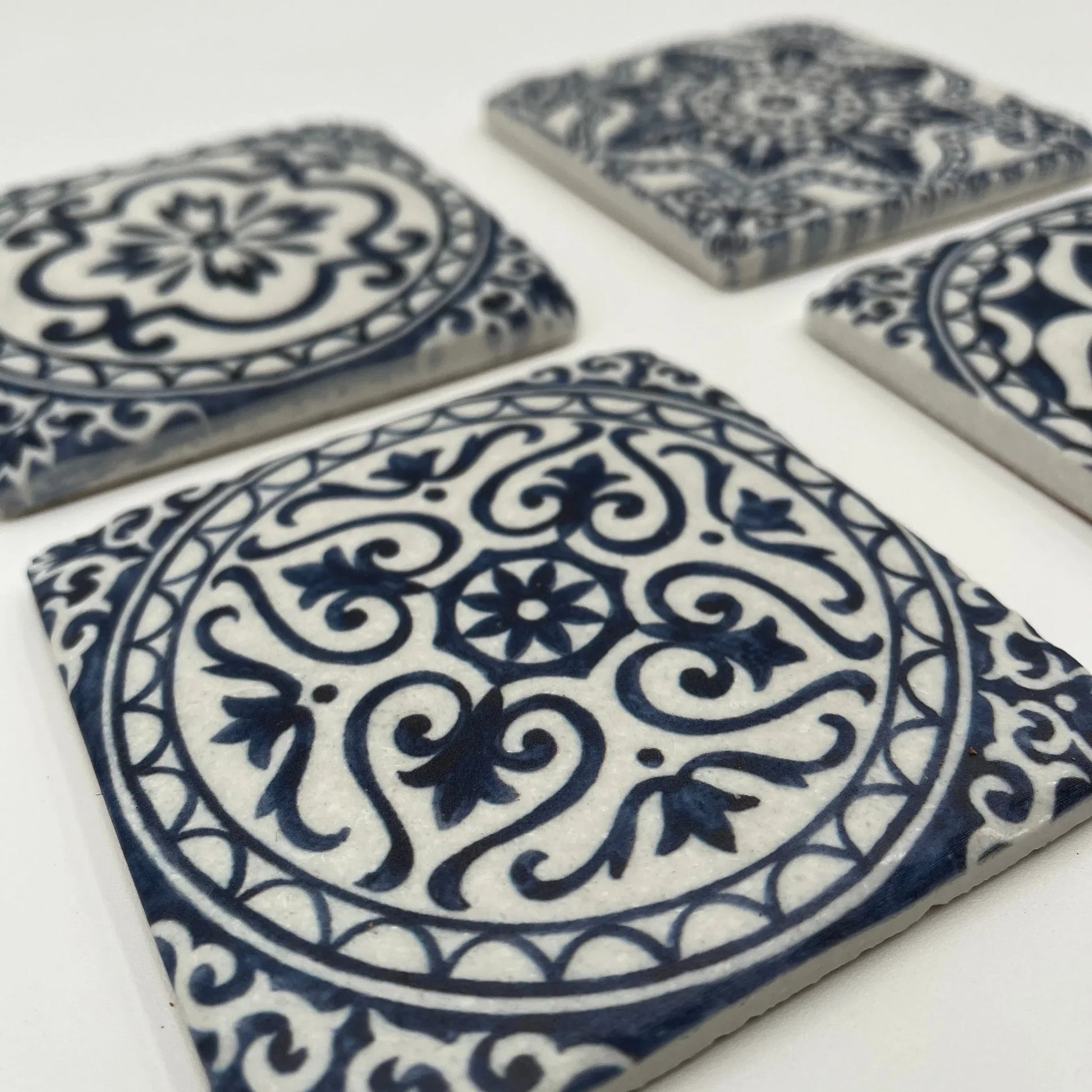 A set of 4 Vintage-style Ceramic Blue Tile Pattern, cork-backed coasters. Inspired by traditional Portuguese and Moroccan patterns