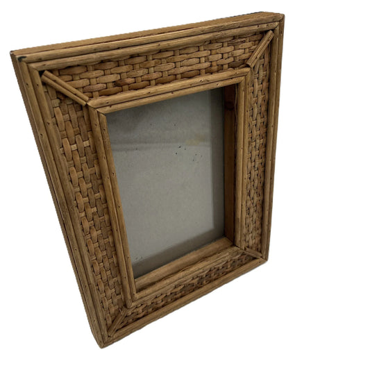 This frame, crafted from rattan, adds a touch of traditional country house charm to any home