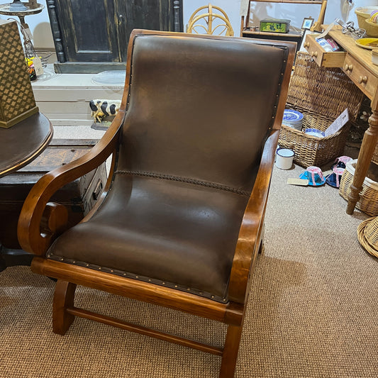 vintage-style leather-and-hardwood chair is inspired by classic British colonial and campaign furniture. 