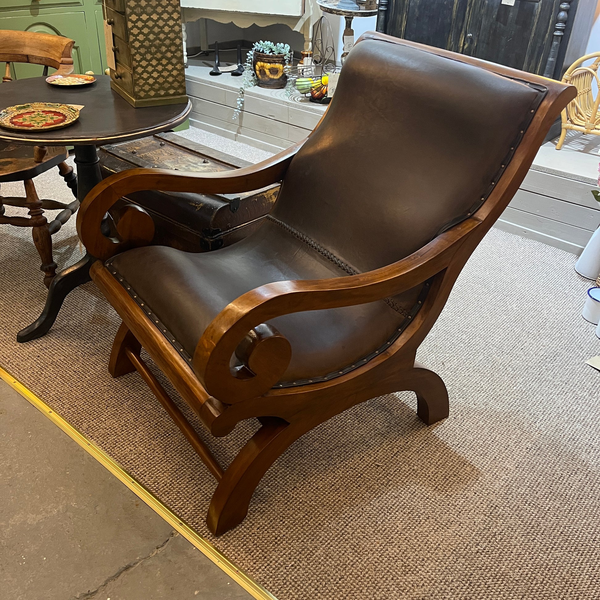 vintage-style leather-and-hardwood chair is inspired by classic British colonial and campaign furniture. 

