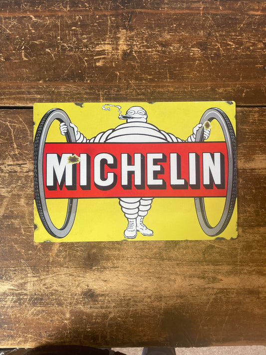 Vintage-Style Michelin man logo Sign  on a wooden background, from Vintage Whippet