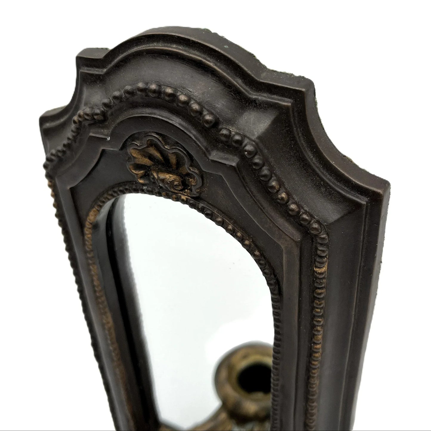 This is a used heavy, vintage-style mirrored wall candle sconce in a bronze-like finish. It has lovely detailing with worn gold accents. It has a felt back with a ring for hanging.