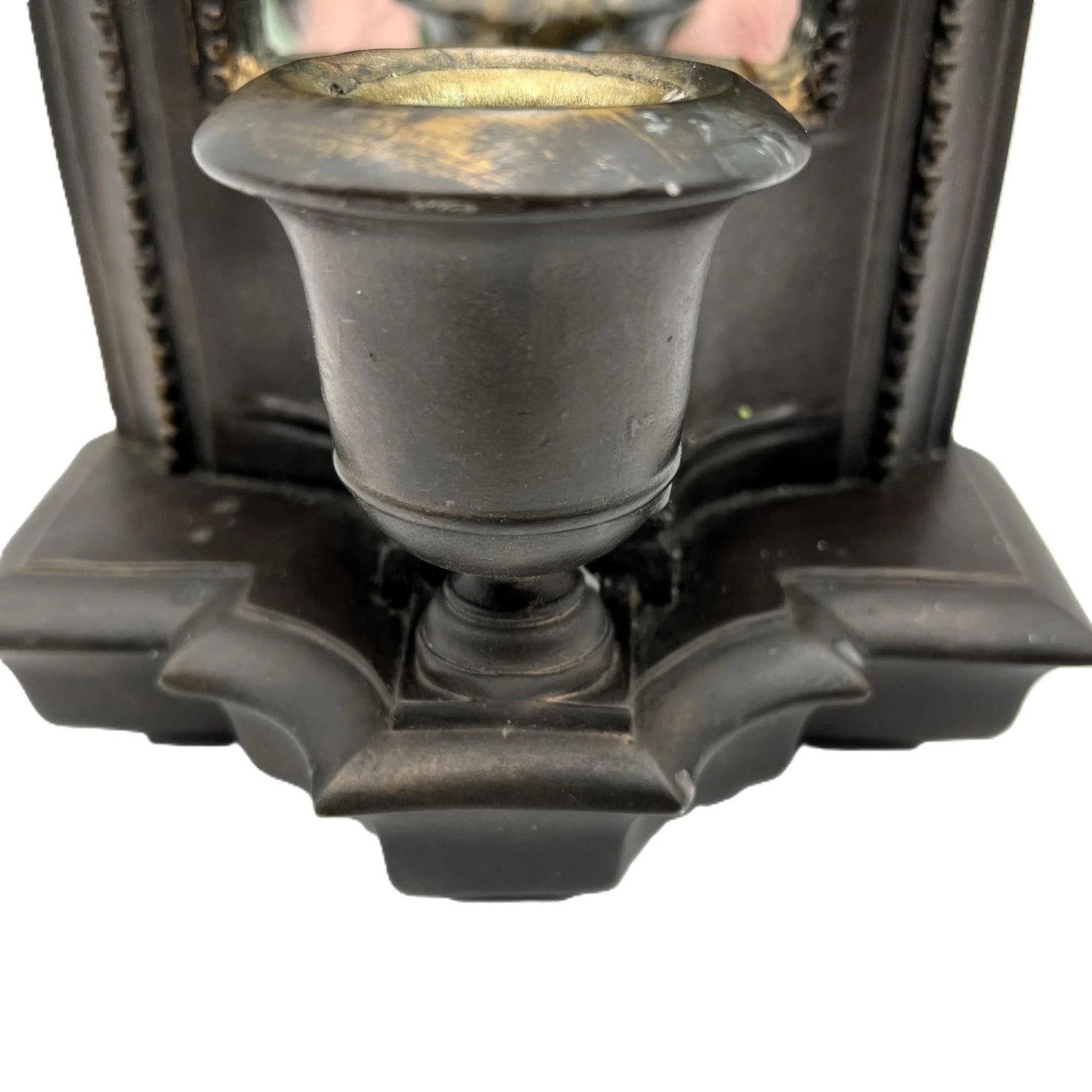 This is a used heavy, vintage-style mirrored wall candle sconce in a bronze-like finish. It has lovely detailing with worn gold accents. It has a felt back with a ring for hanging.