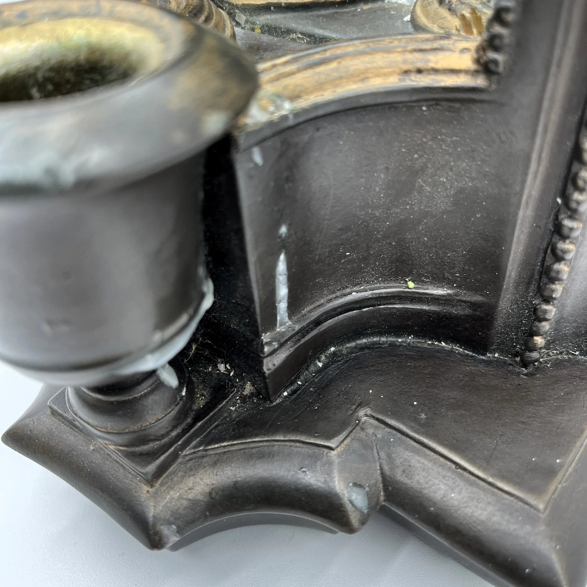 This is a used heavy, vintage-style mirrored wall candle sconce in a bronze-like finish. It has lovely detailing with worn gold accents. It has a felt back with a ring for hanging.