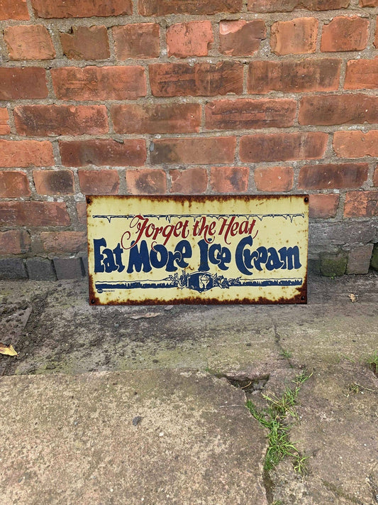 Vintage-style metal sign with text 'Forget the Heat, Eat More Ice Cream' from Vintage Whippet