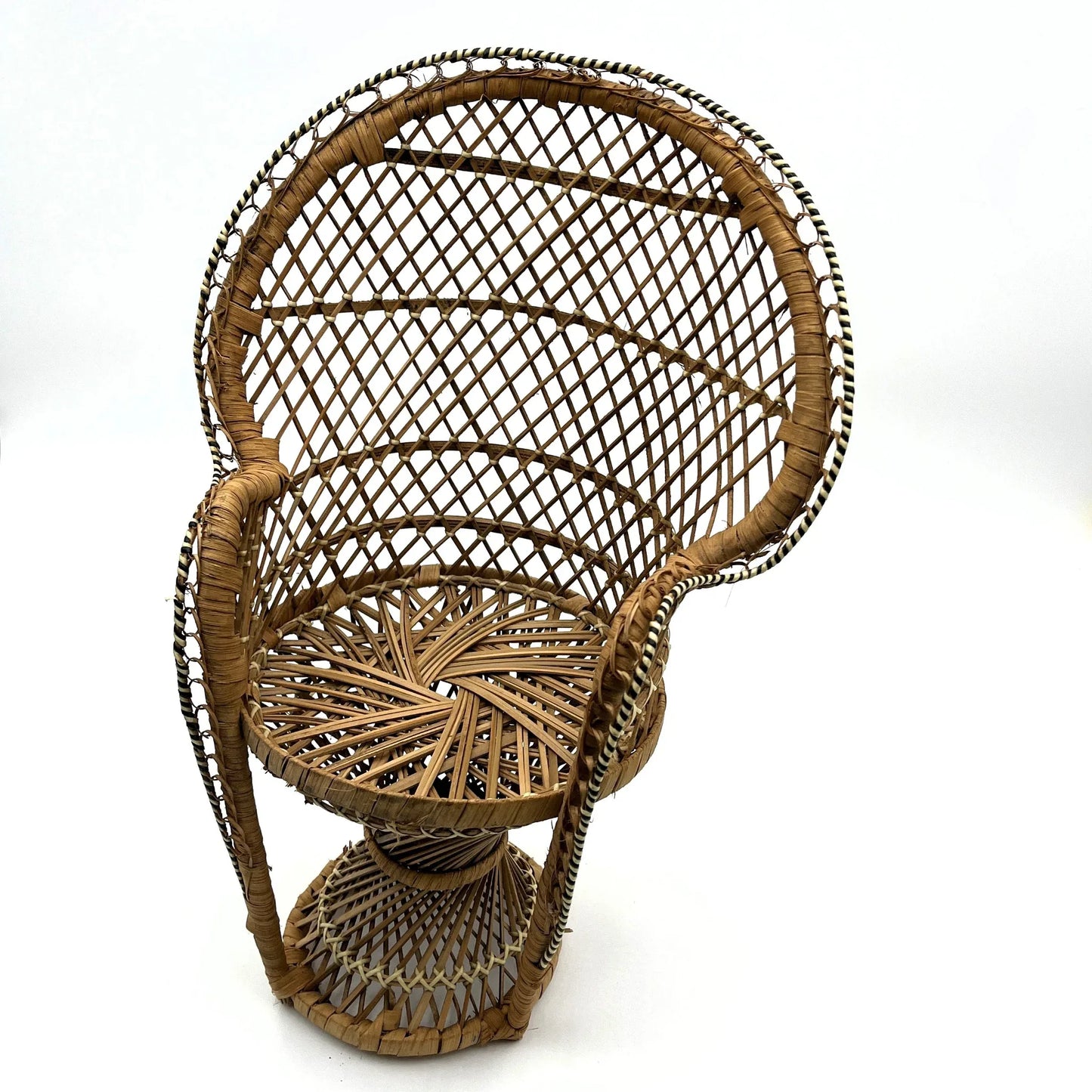 This is a vintage wicker rattan Miniture Peacock Chair with a bohemian pattern. A fun decorative item that can be used to display a plant, teddy or doll.