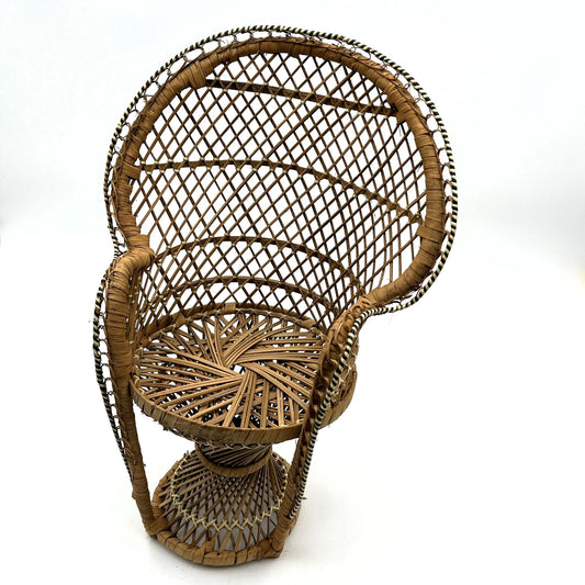 This is a vintage wicker rattan Miniture Peacock Chair with a bohemian pattern. A fun decorative item that can be used to display a plant, teddy or doll.