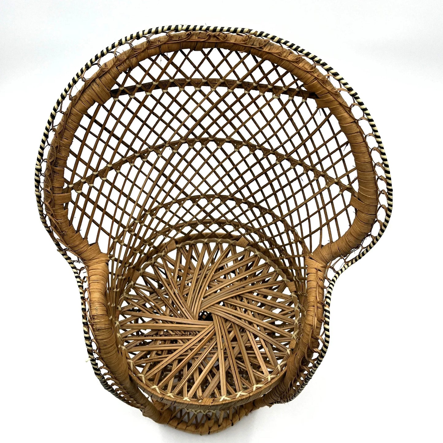 This is a vintage wicker rattan Miniture Peacock Chair with a bohemian pattern. A fun decorative item that can be used to display a plant, teddy or doll.