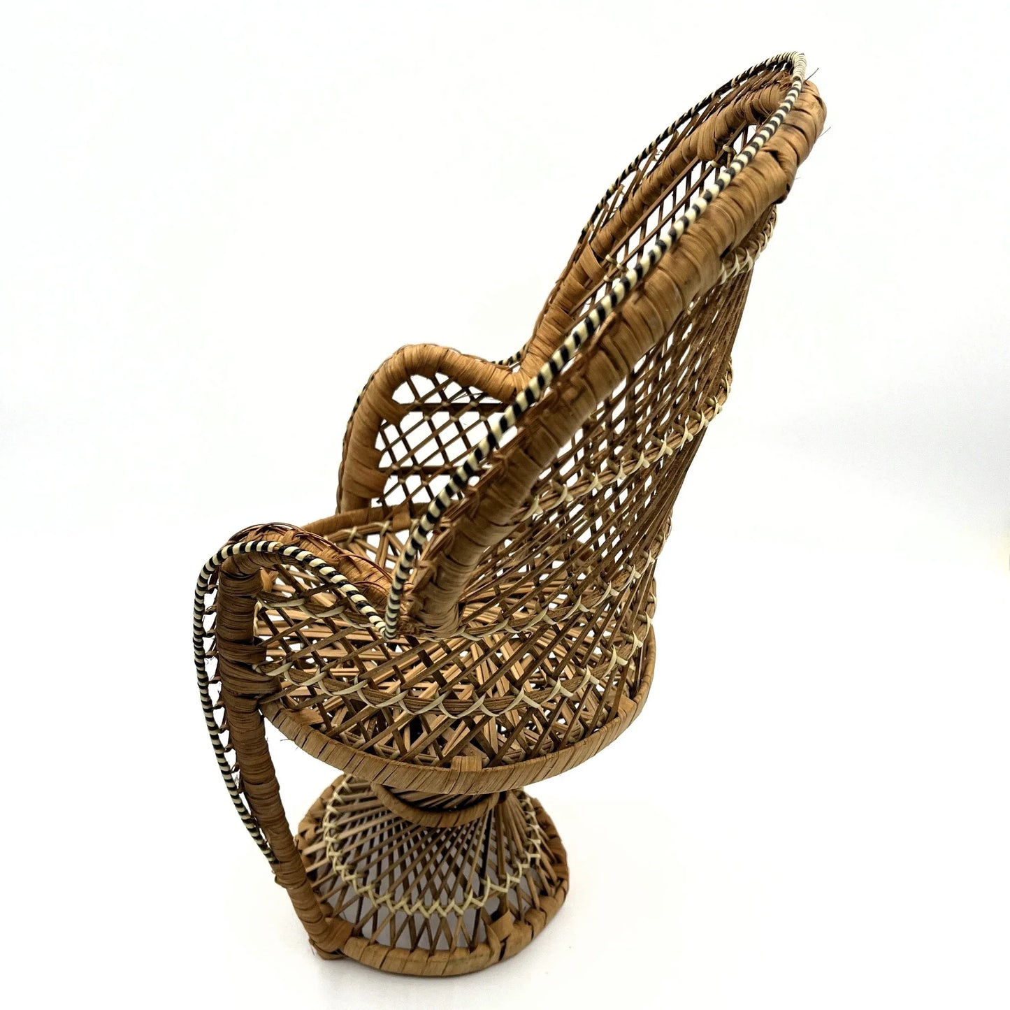 This is a vintage wicker rattan Miniture Peacock Chair with a bohemian pattern. A fun decorative item that can be used to display a plant, teddy or doll.
