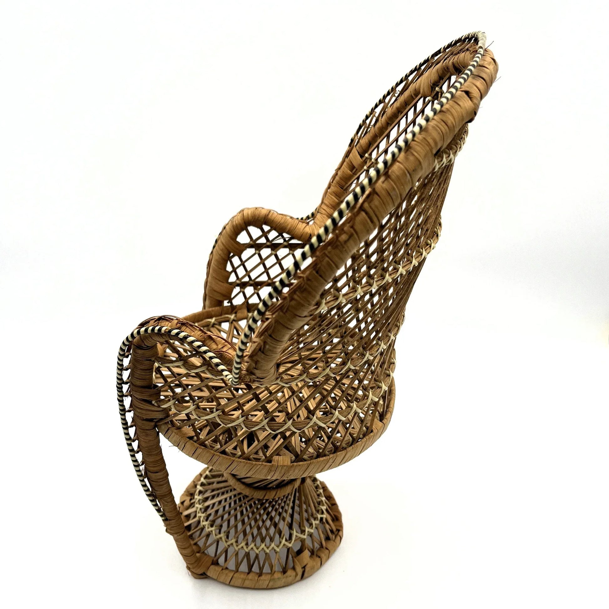 This is a vintage wicker rattan Miniture Peacock Chair with a bohemian pattern. A fun decorative item that can be used to display a plant, teddy or doll.