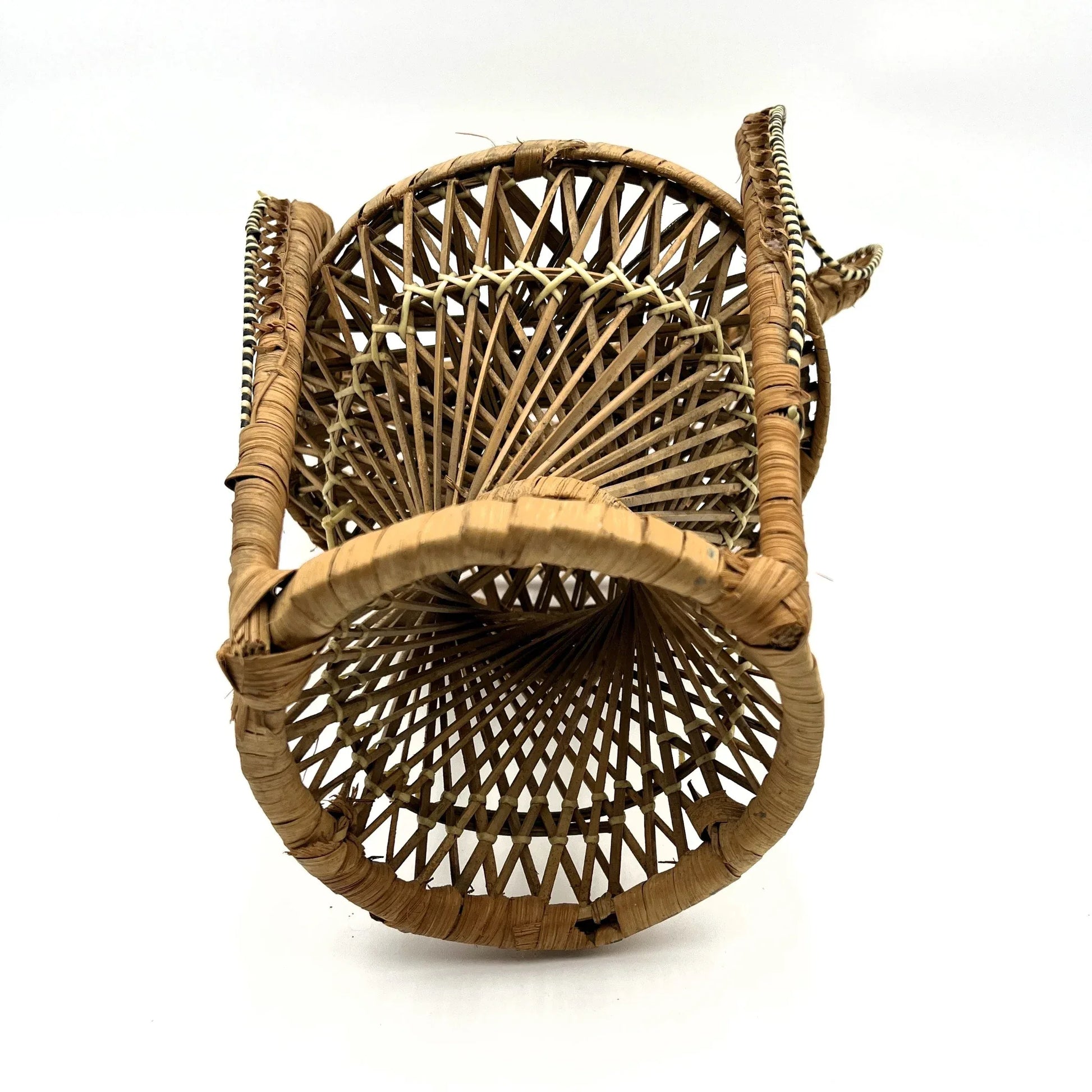 This is a vintage wicker rattan Miniture Peacock Chair with a bohemian pattern. A fun decorative item that can be used to display a plant, teddy or doll.