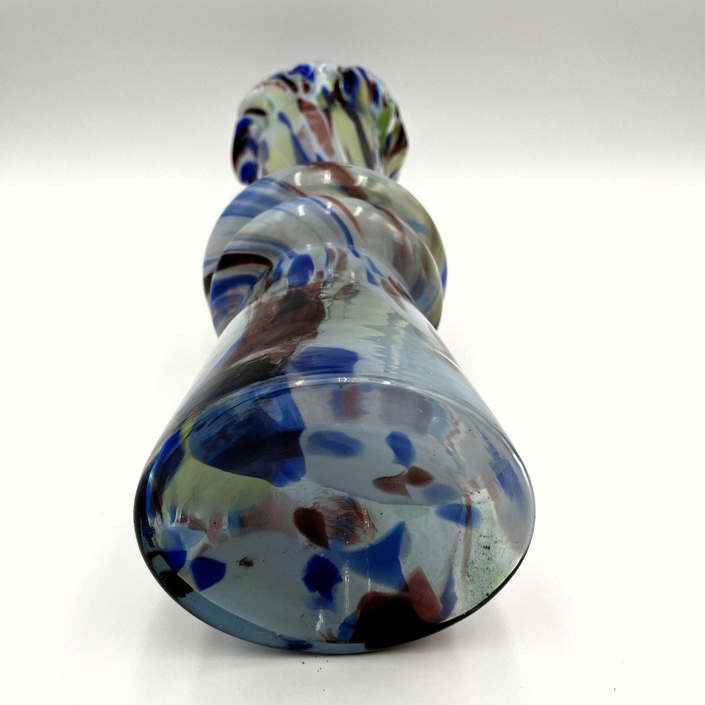 This mid-century Spatter or End of Day Vase.  It features a colorful "end of the day" or splatter design with blue, red, white, and black colours under clear glass.