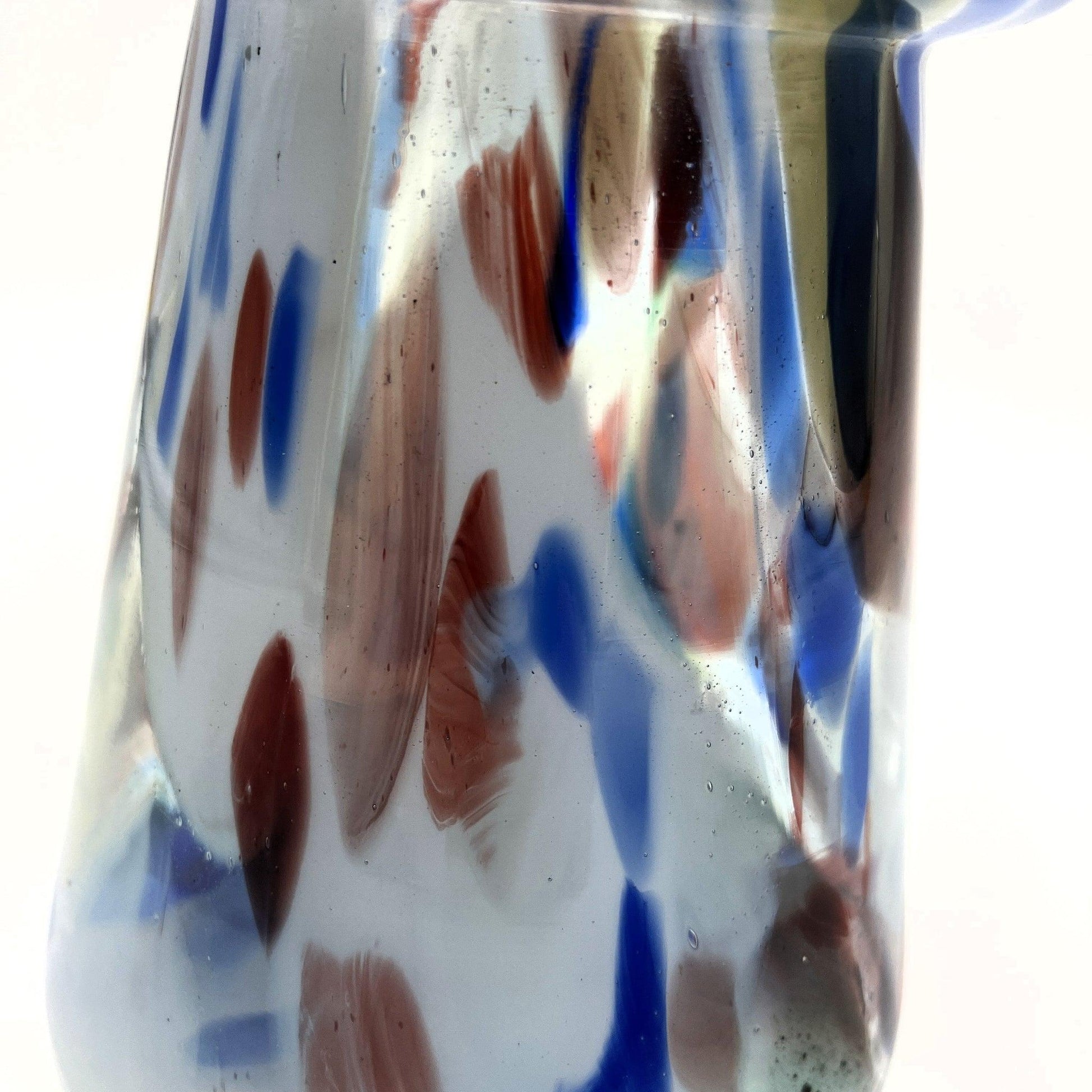 This mid-century Spatter or End of Day Vase.  It features a colorful "end of the day" or splatter design with blue, red, white, and black colours under clear glass.