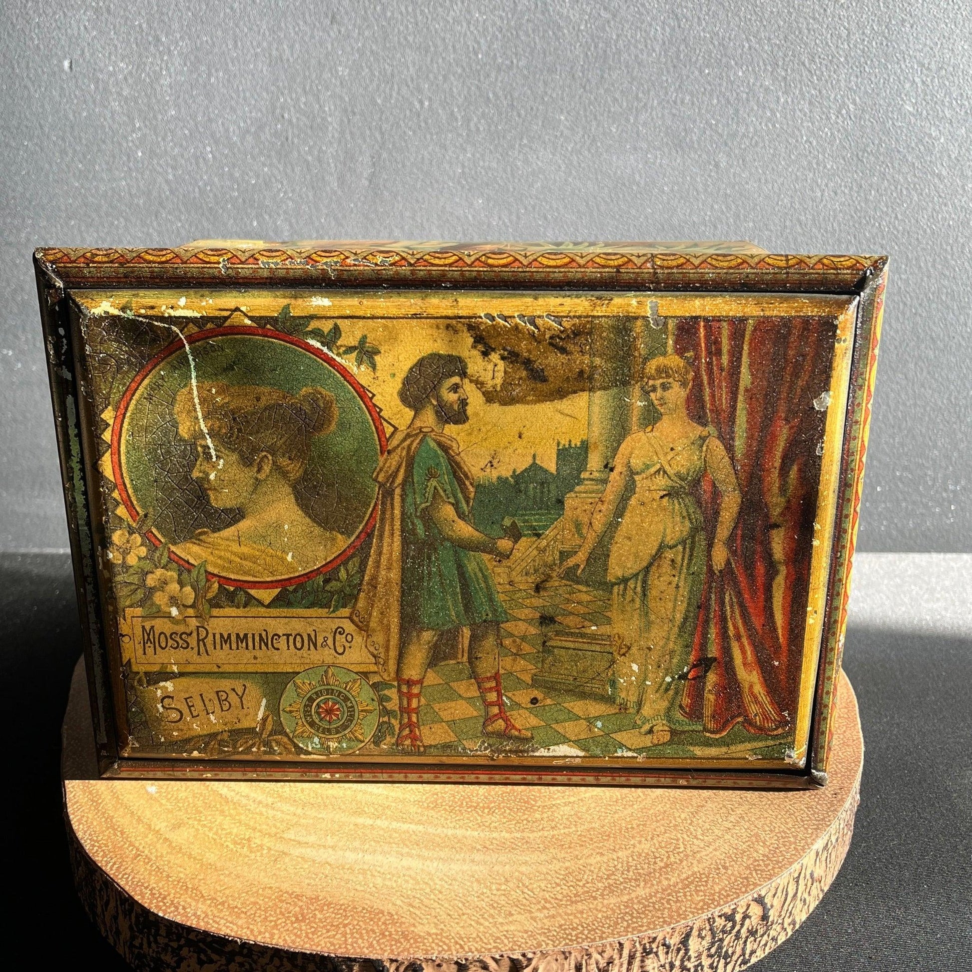 This is a Vintage early 1900s, Moss Rimmington and Co Mustart Tin, Selby Works, West Riding Mills. On the sides of the tin, there are lithographic images of plays and their characters.