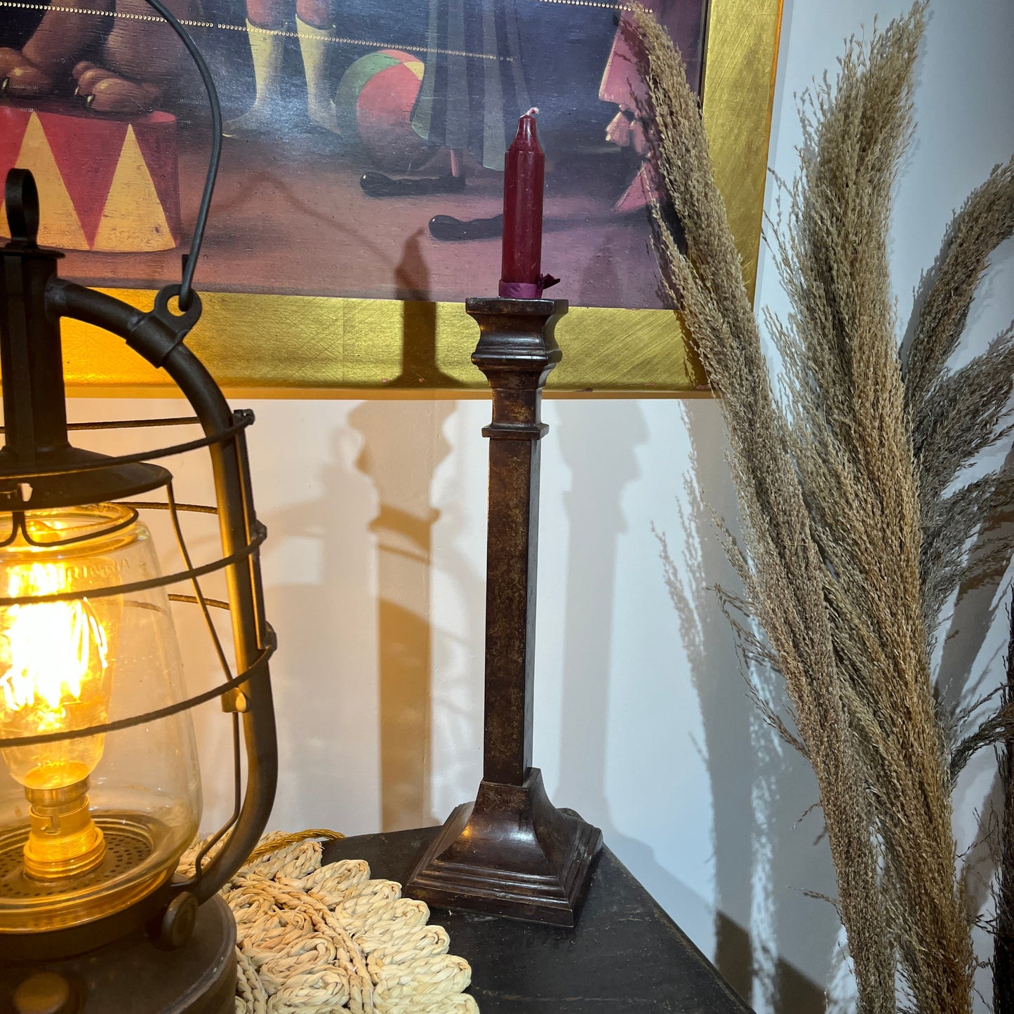 These are a heavy pair of cast metal candlesticks with a bronze or bronze coloured metal patina look. 