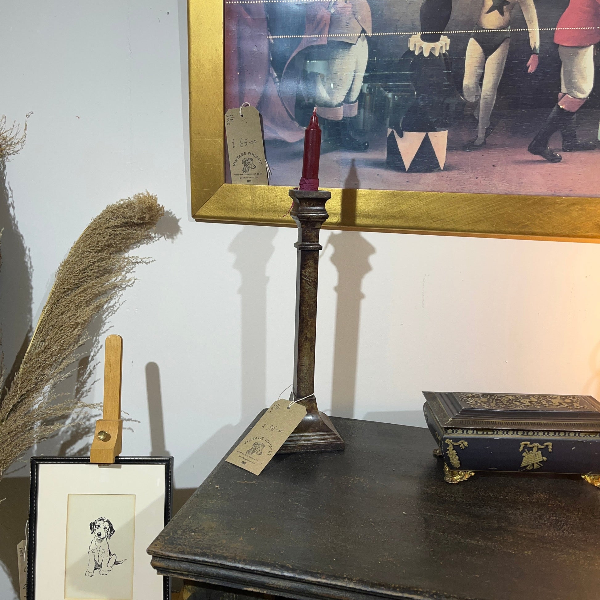 These are a heavy pair of cast metal candlesticks with a bronze or bronze coloured metal patina look. 