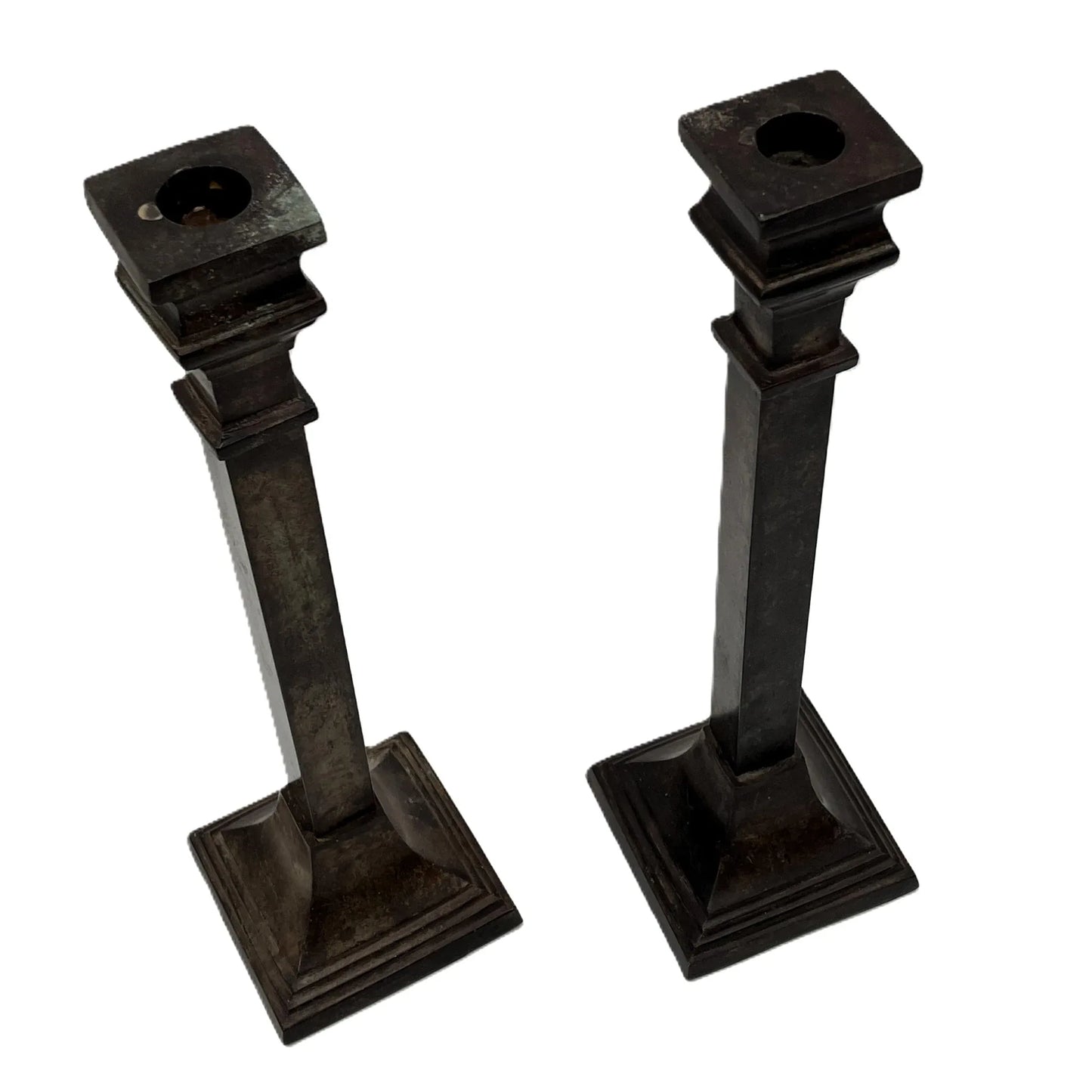These are a heavy pair of cast metal candlesticks with a bronze or bronze coloured metal patina look. 